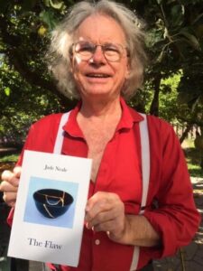 Richard Olafson, the publisher of Jude Neale's books of poetry holds a copy of her latest book, The Flaw